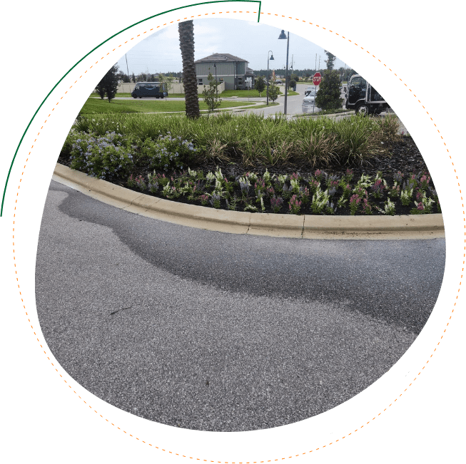 Commercial landscaping Davenport FL HOA entrance bed maintenance with fresh mulch, edging, and seasonal flowers
